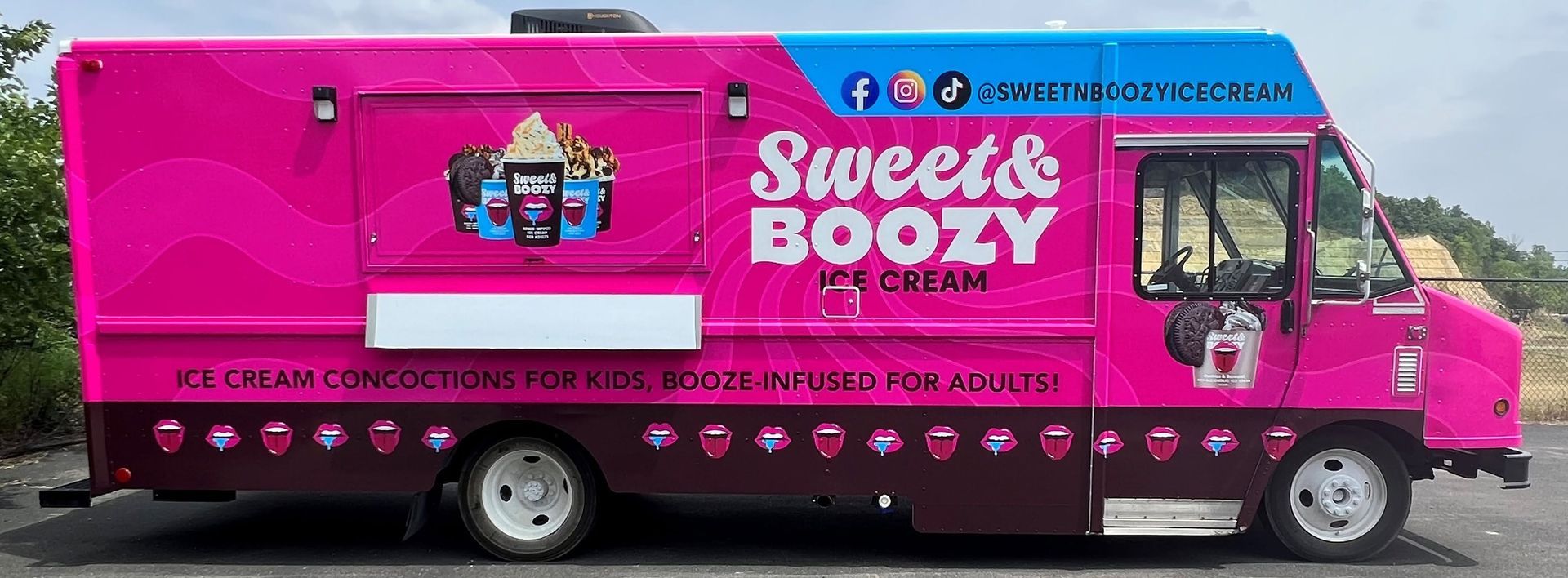 Bright pink Sweet & Boozy truck with signage and drink-themed graphics on the side