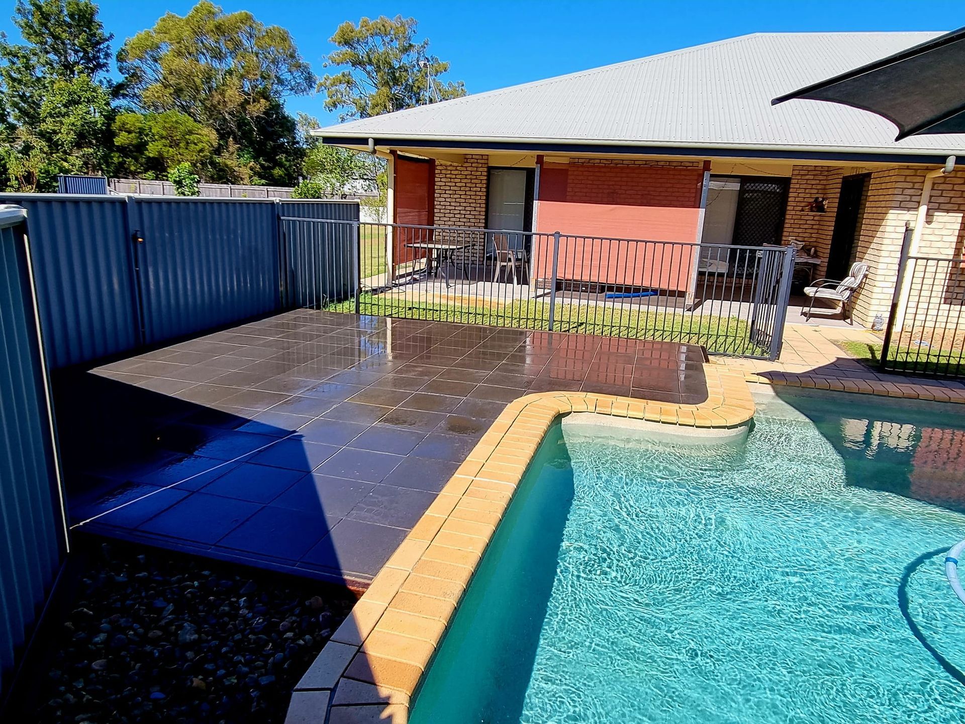 Backyard With a Pool, Patio, and House — On The Mark Landscaping in Branyan, QLD