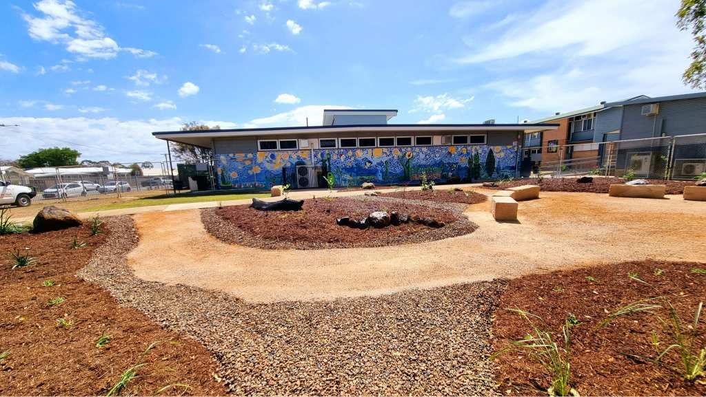 School Building With Mural, Surrounded by a Garden With Mulch and Stones — On The Mark Landscaping in Branyan, QLD