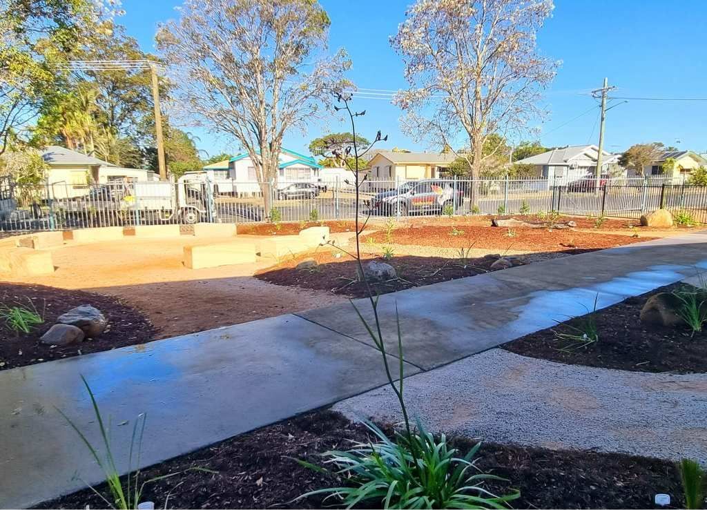 Pathway Through a Garden With Trees, Houses in Background — On The Mark Landscaping in Branyan, QLD