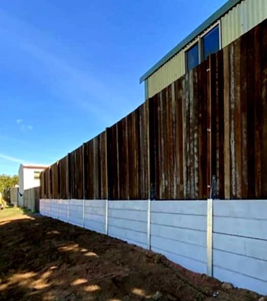 Long Wooden Fence With a White Concrete Base — On The Mark Landscaping in Branyan, QLD