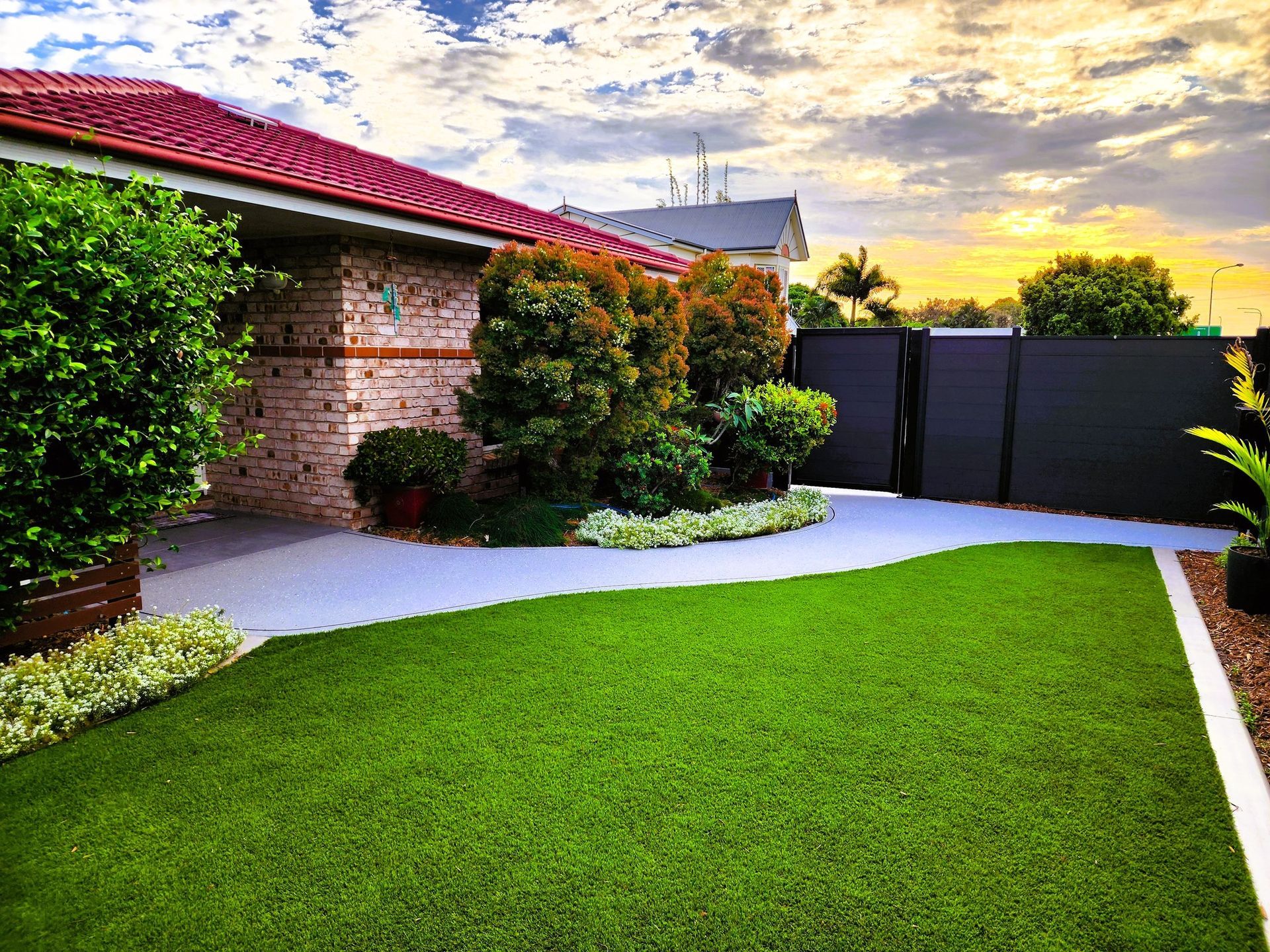 A House With a Red Tiled Roof and Well-manicured Lawn — On The Mark Landscaping in Branyan, QLD