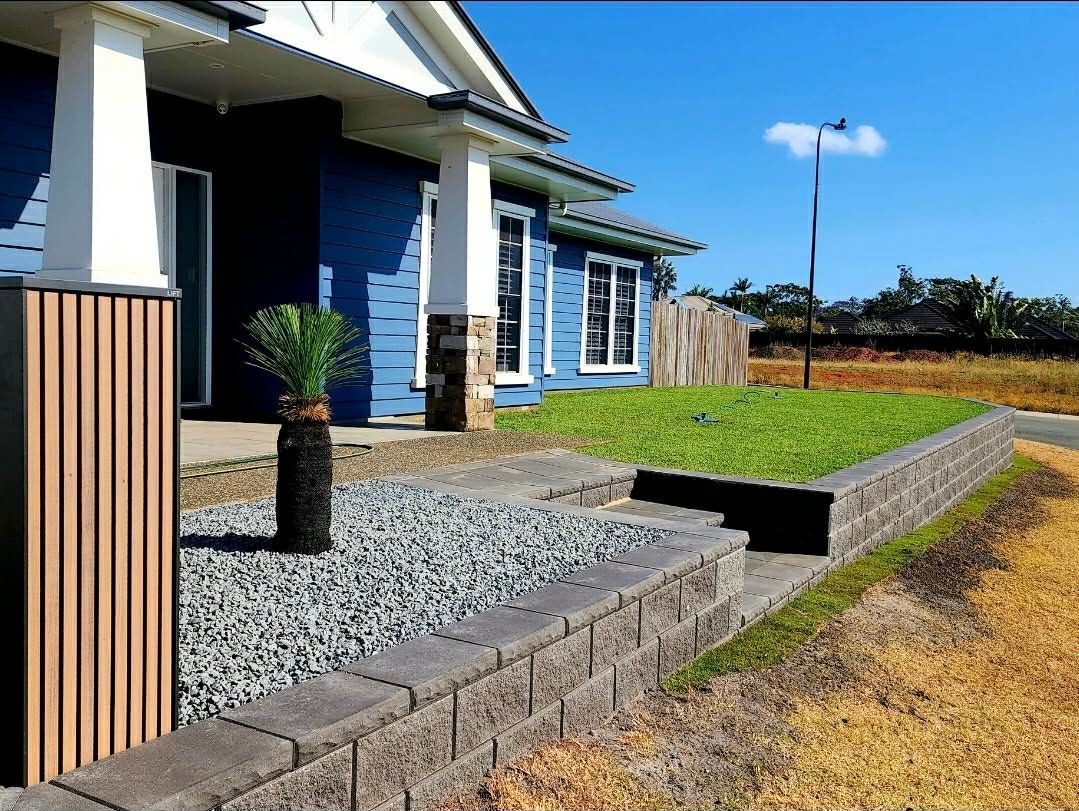 Blue House With Stone Retaining Wall, Gravel Pathway, and Potted Palm Tree — On The Mark Landscaping in Branyan, QLD