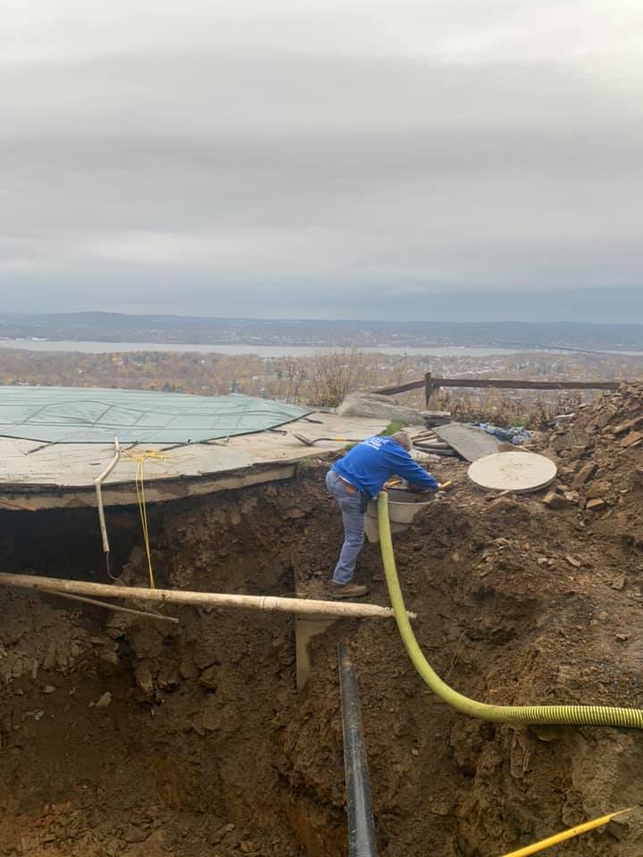 Worker Unclogging Septic Tank — Mahopac, NY — Evans Septic Tank Service