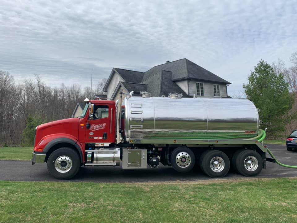 Red Truck in Residential Area — Mahopac, NY — Evans Septic Tank Service