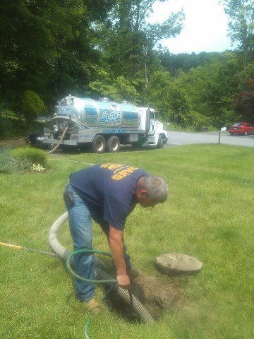 Worker Cleaning Septic Tank — Mahopac, NY — Evans Septic Tank Service