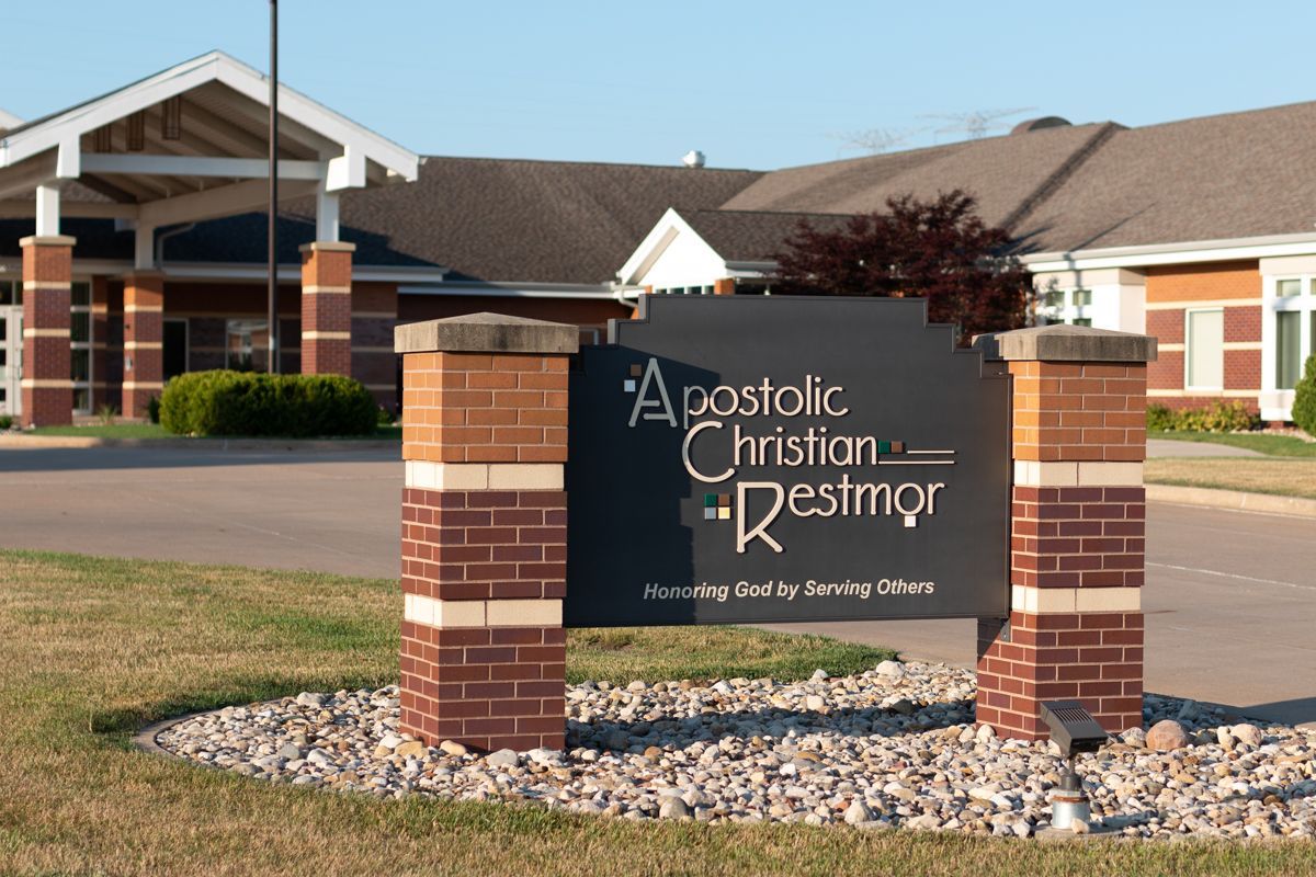 A sign in front of a building that says Apostolic Christian Restmor