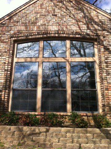 A large window on the side of a brick building