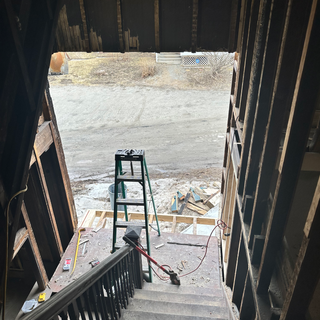 A ladder is sitting on the steps of a building under construction