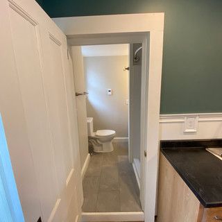 A bathroom with a toilet , sink , and shower.