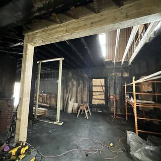 The inside of a building under construction with scaffolding and tools