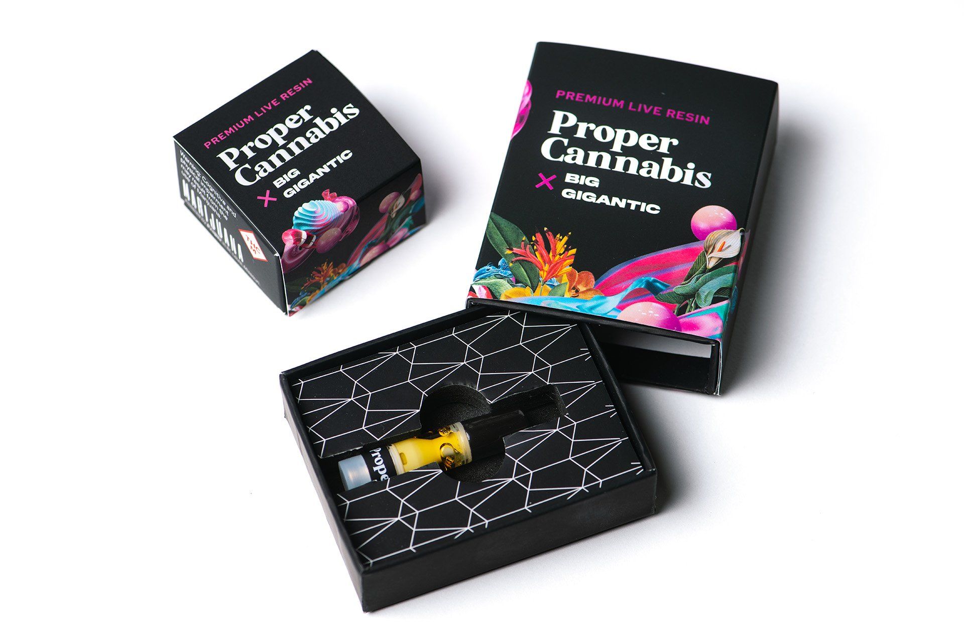 Three black cannabis product boxes with colorful psychedelic artwork, one open to show a glass pipe and yellow herb.