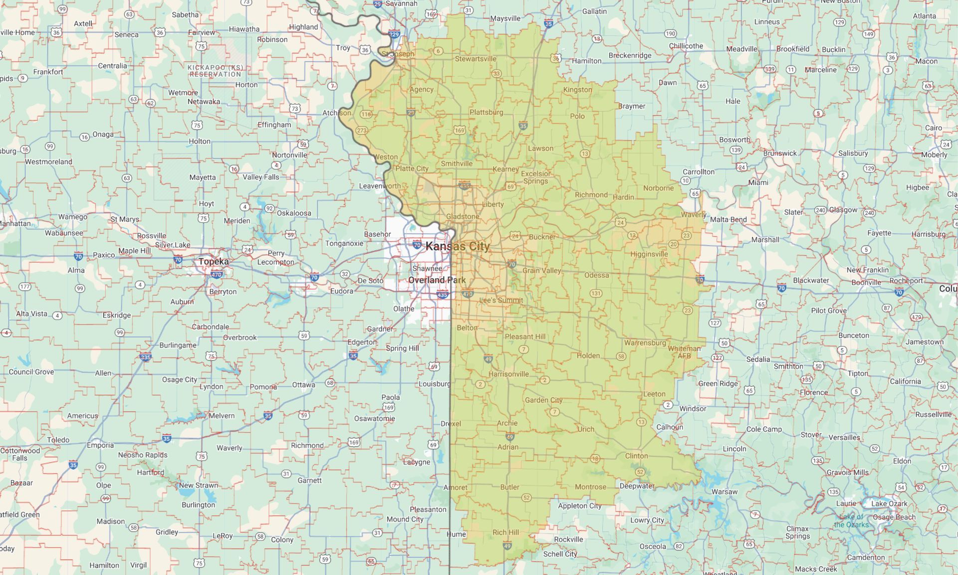 Map with a large yellow-green highlighted region outlined in darker green over a street map.