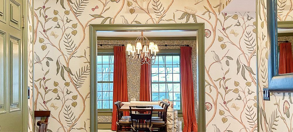 A dining room with a table and chairs and a chandelier.