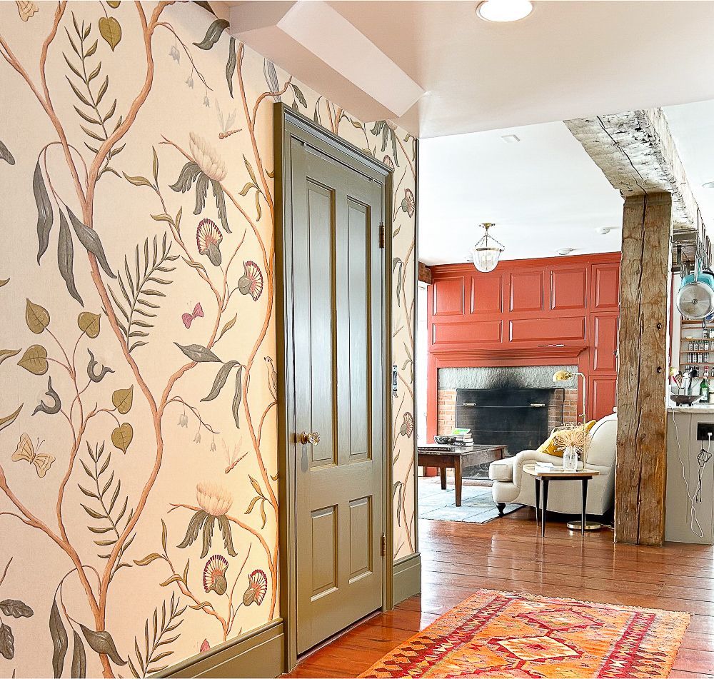 A hallway with a floral wallpaper on the wall