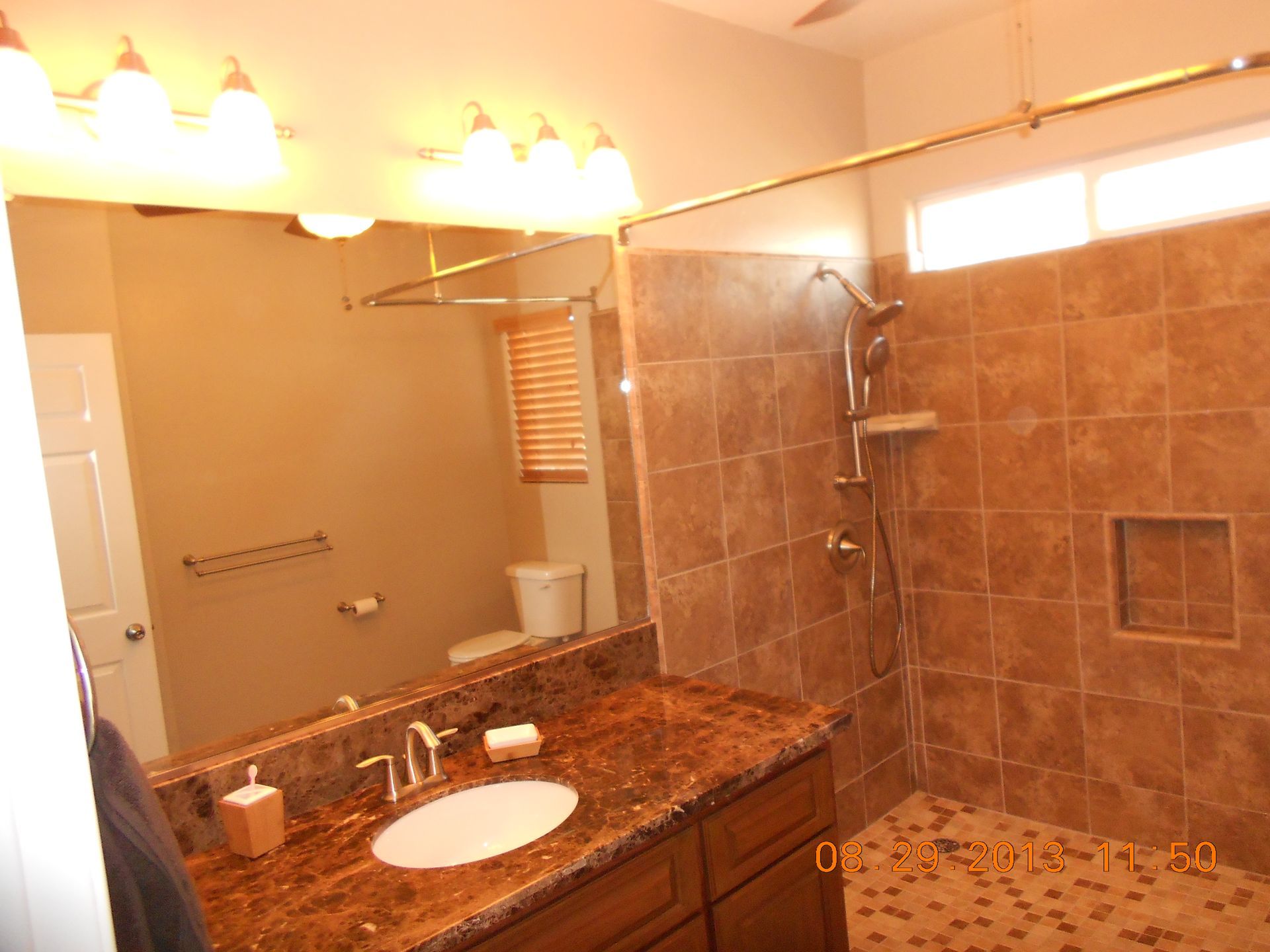 A bathroom with a sink and a walk in shower