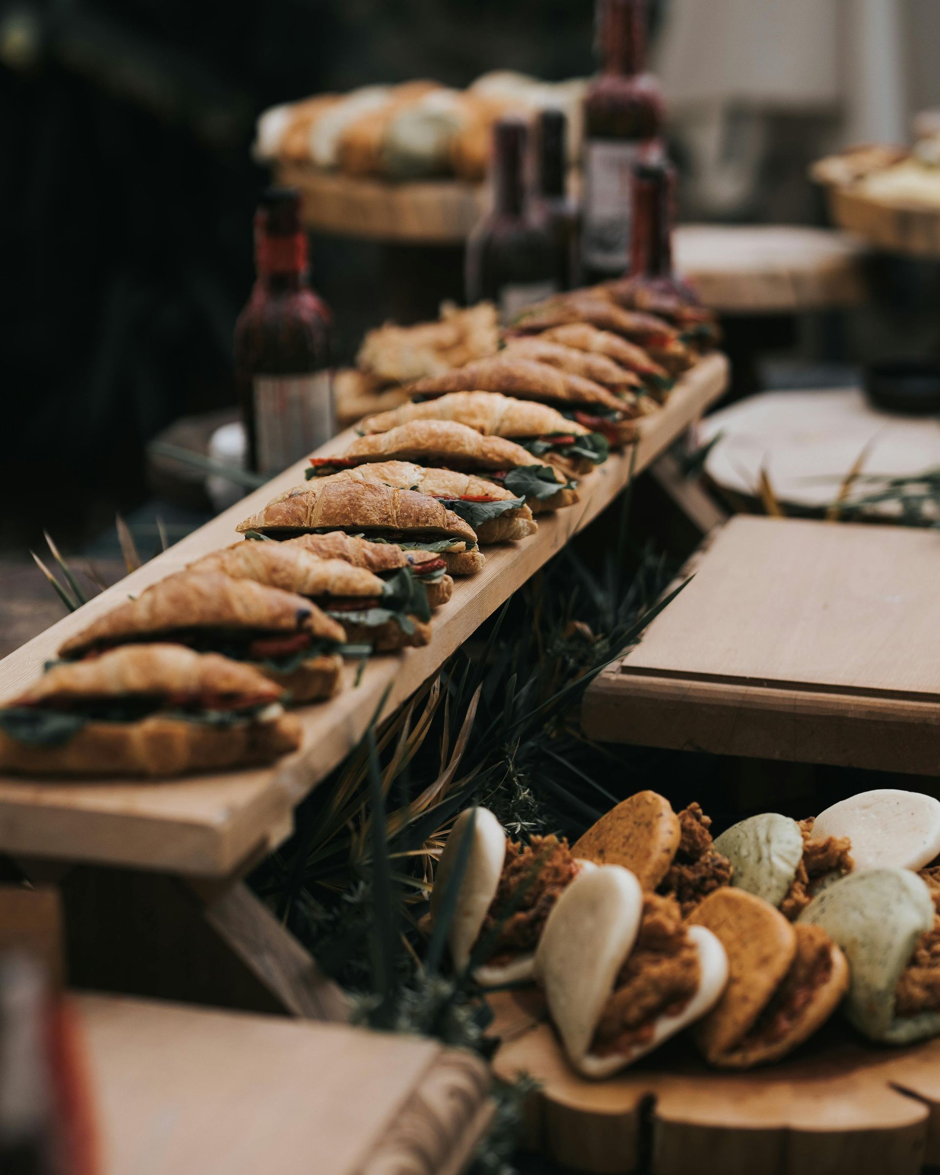 Tray of assorted pastries and sandwiches on a buffet table at a catered event