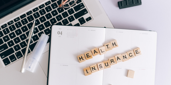 private insurance paper laying on computer