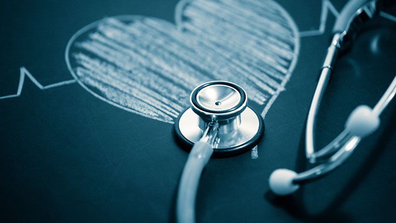 stethoscope laying on chalk drawing of a heart