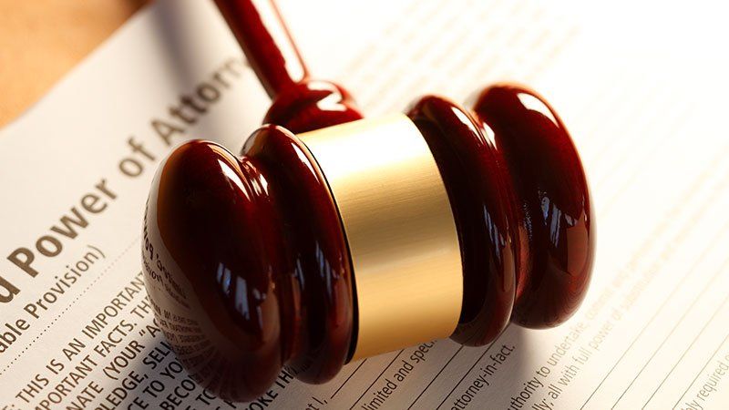 Gavel laying on paper that says