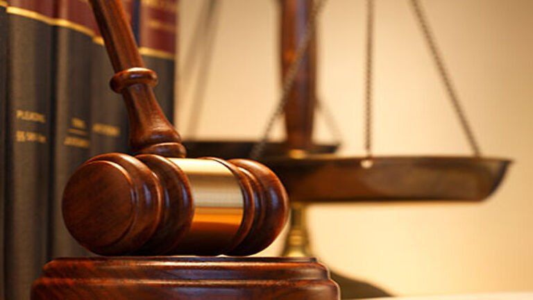 gavel in front of books and a justice scale