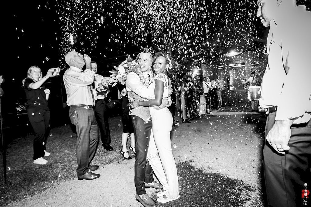 Couple embracing during a confetti shower at a nighttime celebration