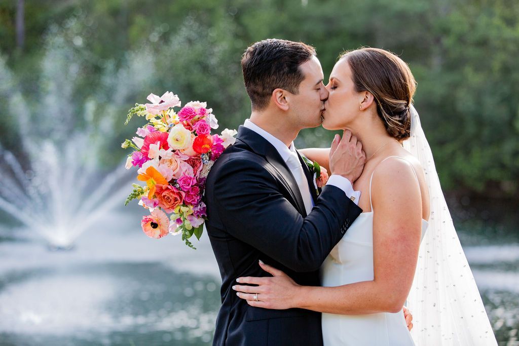 Kiss at the pond fountain Hart Meadows Ranch