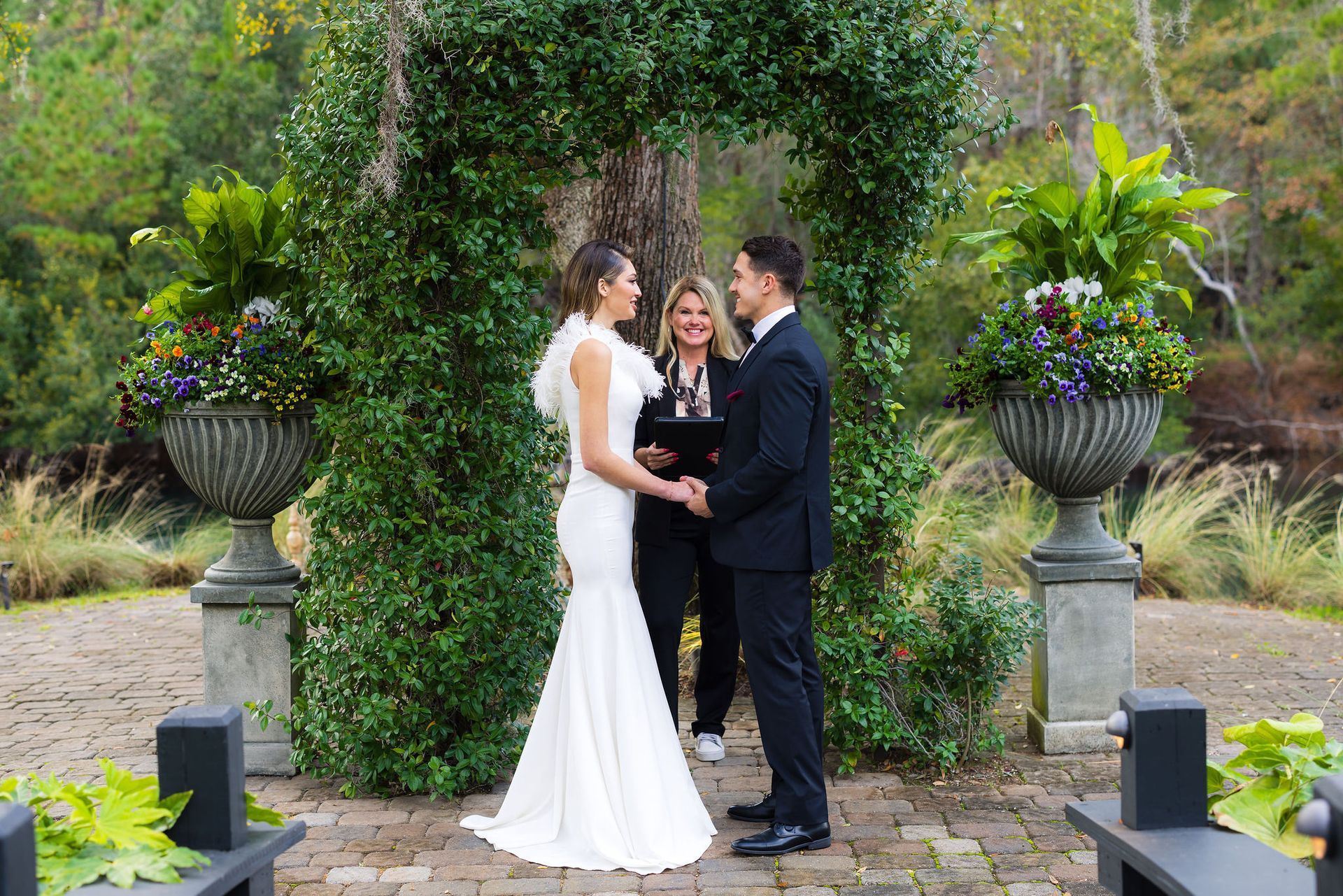 Bride and groom exchanging vows in a garden wedding ceremony