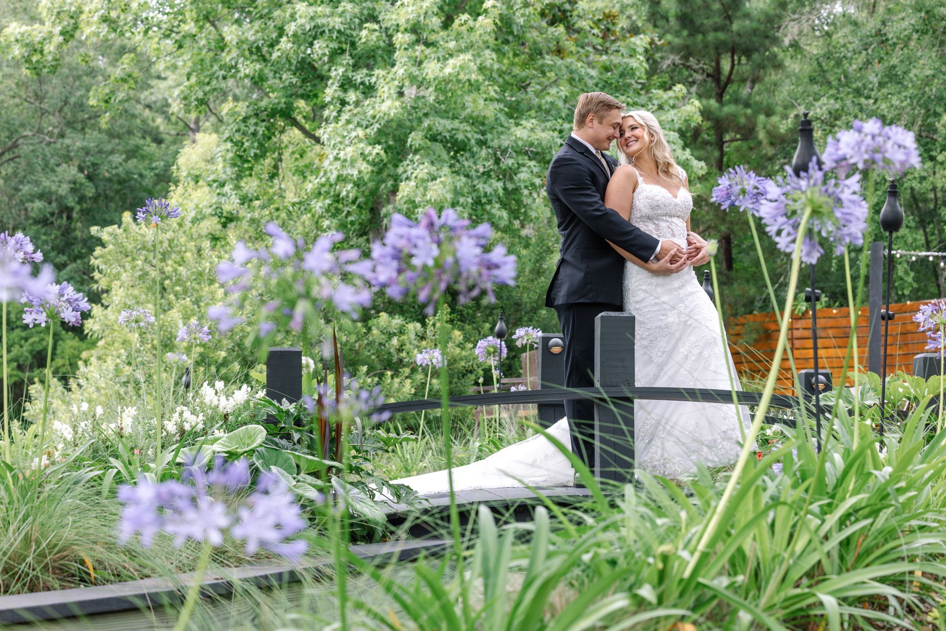 Bride and groom on Hart Meadows Ranch bridge