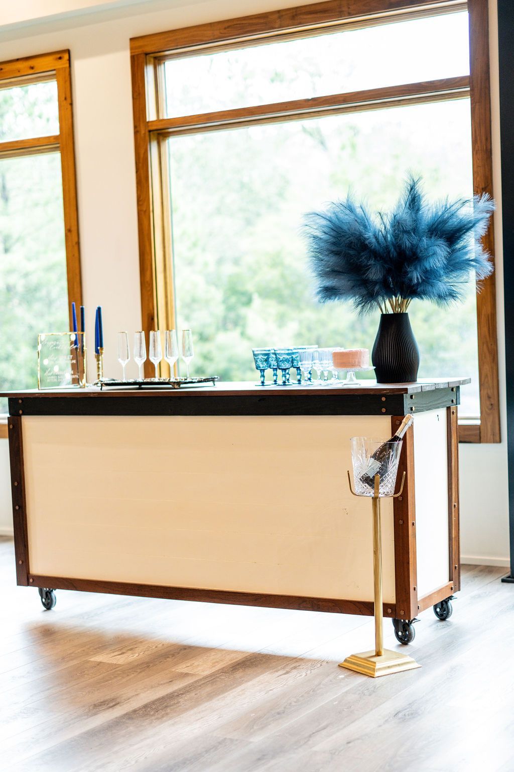Modern desk by large windows with a blue vase and bright natural light
