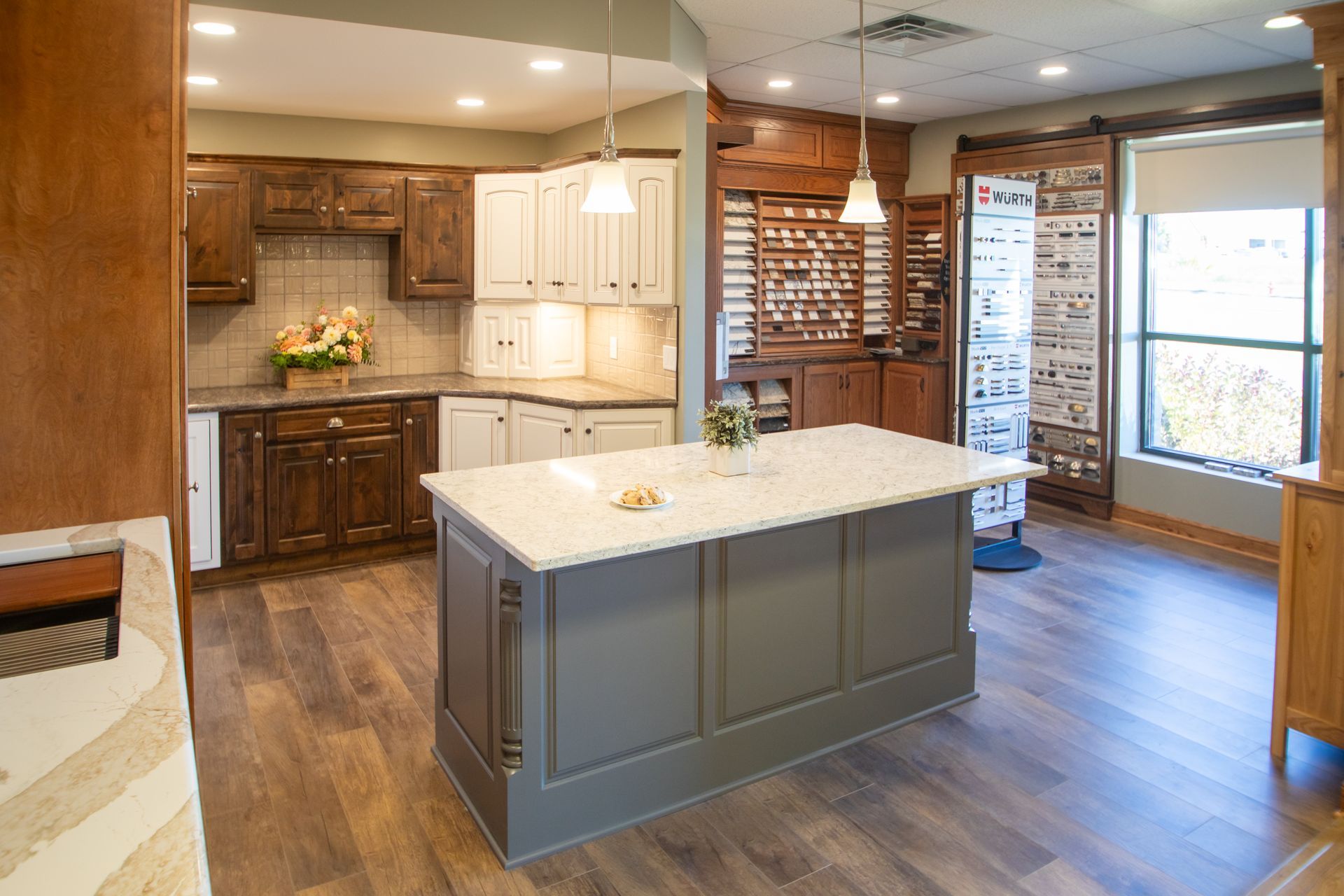 Kitchen display with dark wood and white cabinets, gray island, and sample display.