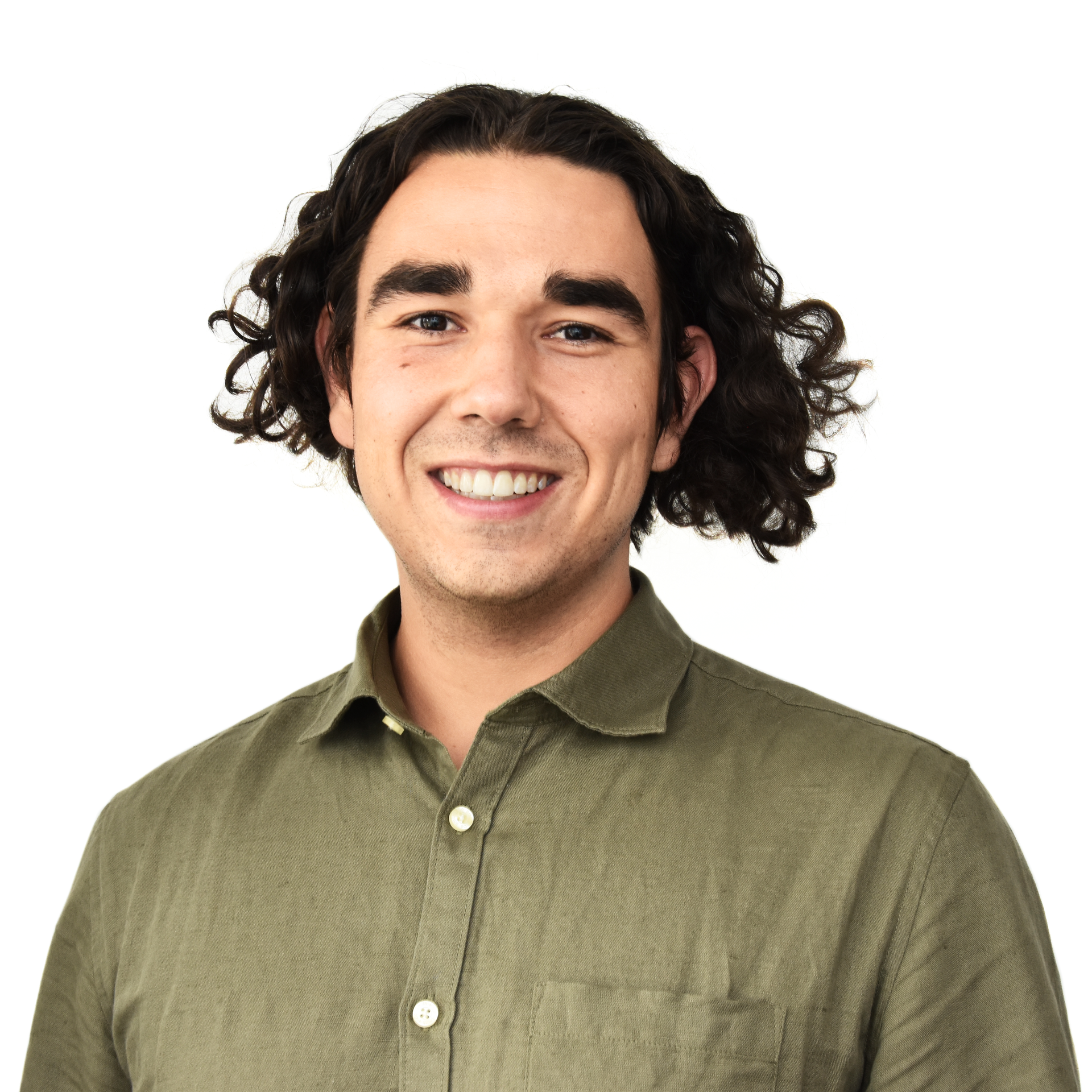 Smiling person with curly dark hair wearing an olive-green shirt against a white background