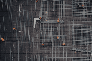 An aerial view of a group of construction workers working on a building under construction.