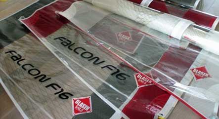 Plastic Falcon F16 toy airplane packaging in red, white, and clear sleeves on a tabletop