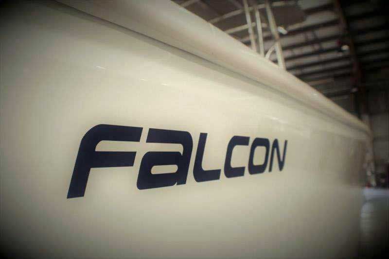Close-up of a white surface with a dark blue Falcon logo in an industrial setting