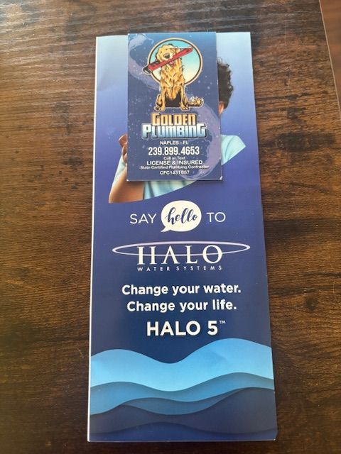 Brochure for Halo water systems, held together by a Golden Plumbing business card. Dark blue background.