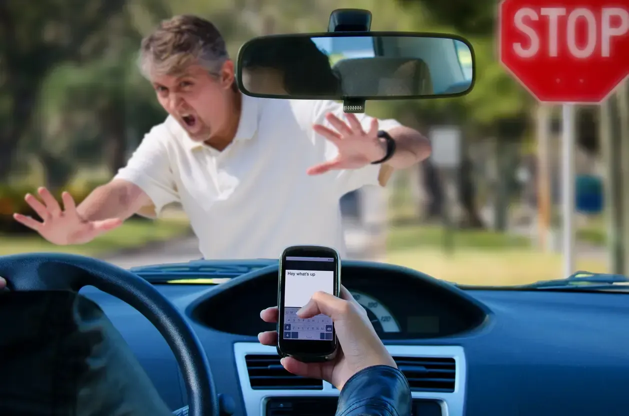 Driver distracted by texting approaching a pedestrian at an intersection in Ontario