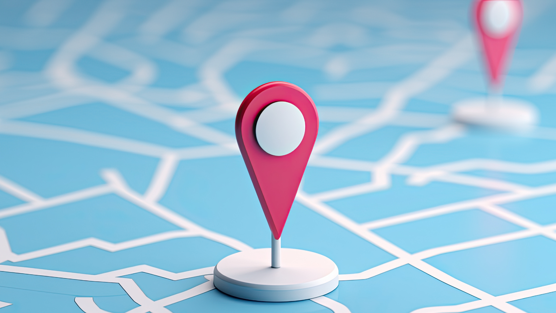 Two pink 3D map location pins stand on a blue surface featuring a stylized white road map grid.