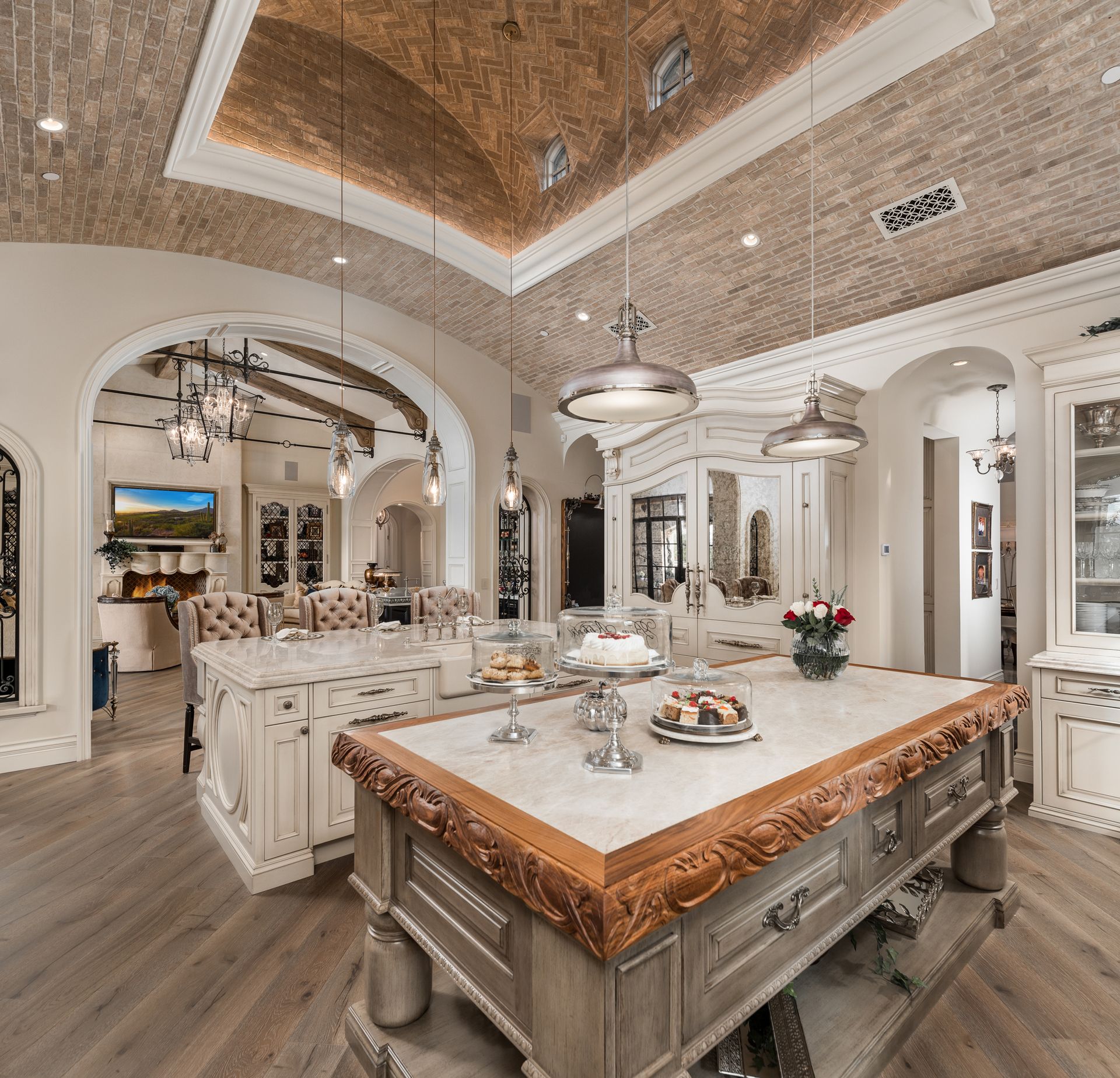 French Villa dining room with arched ceiling, white furnishings, and a large central table