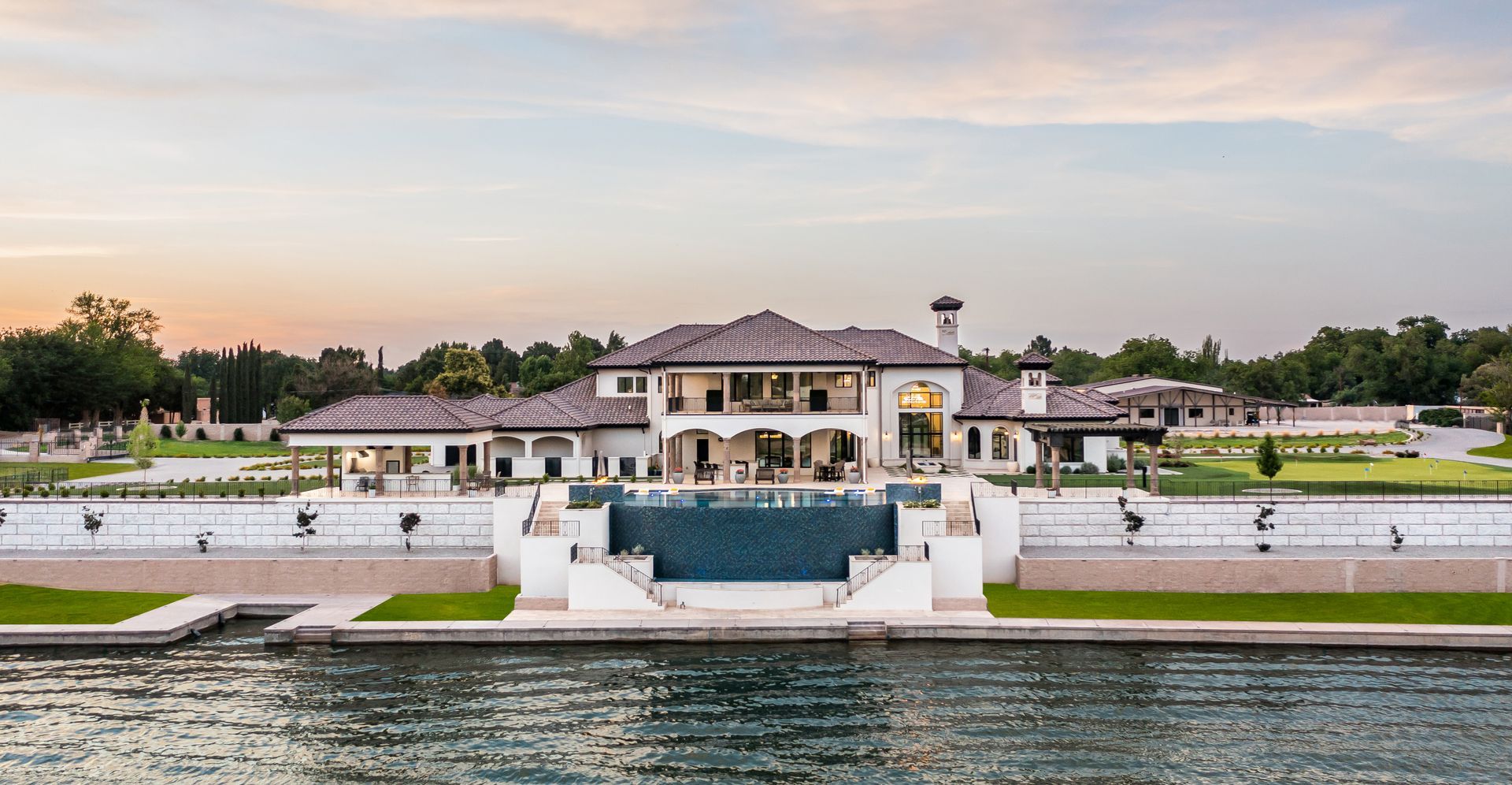 Luxury waterfront estate with resort-style outdoor amenities
