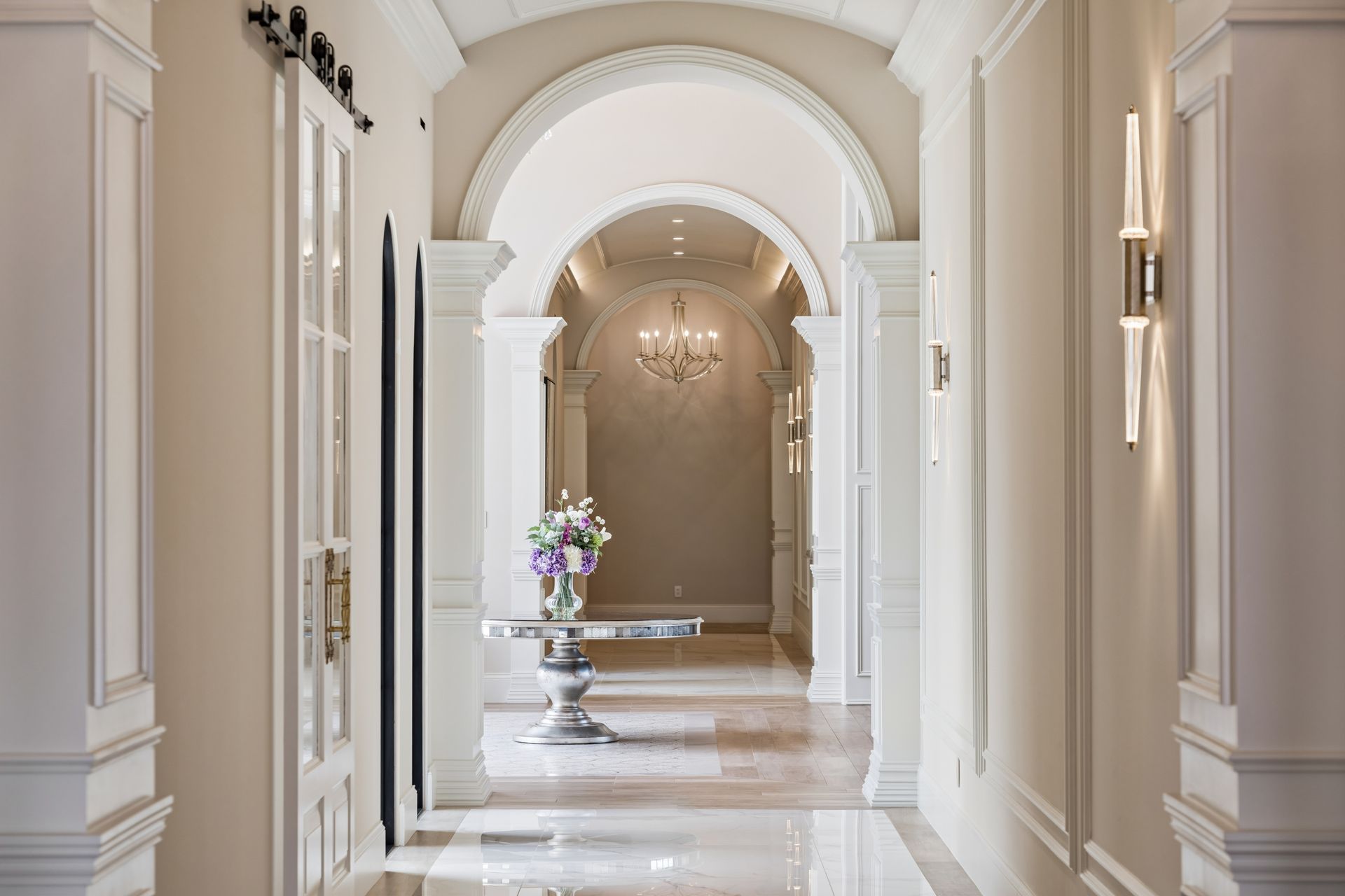 Luxury home hallway with millworker and arched doorways