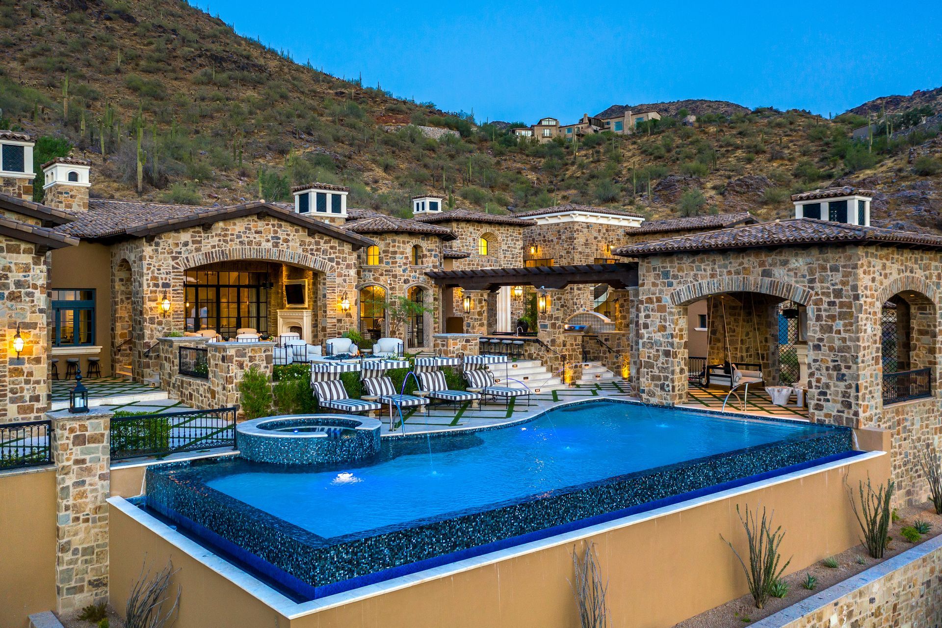 Luxury hillside Scottsdale home with a blue infinity pool overlooking mountains