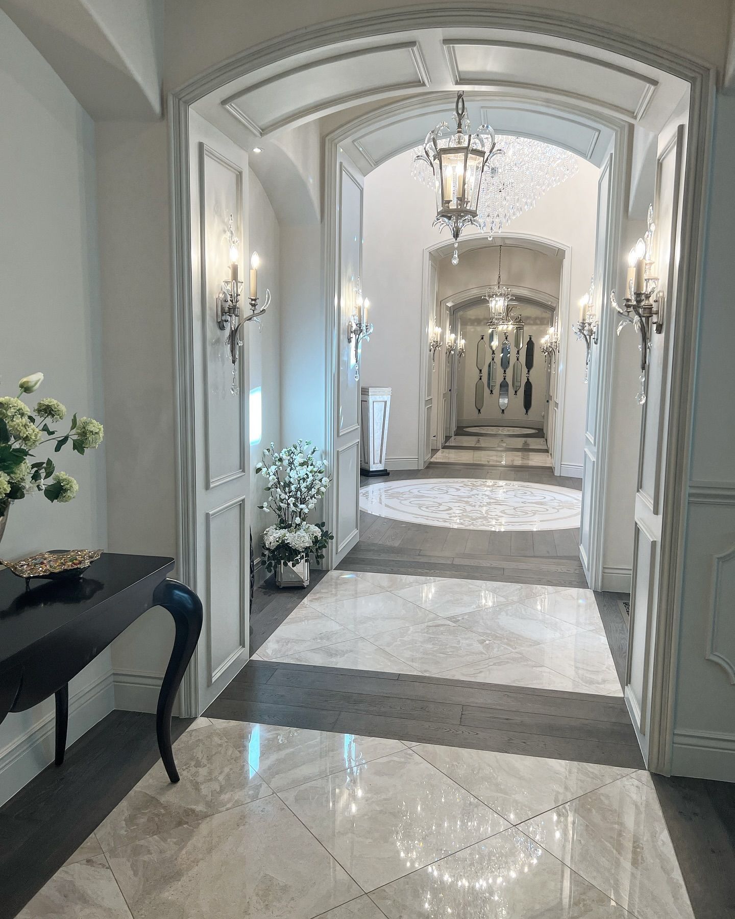 Luxury old world hallway with inlay mosaic, wood and marble flooring and arched doorways