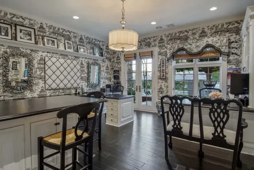 French-style home interior with toile wallpaper and chandelier