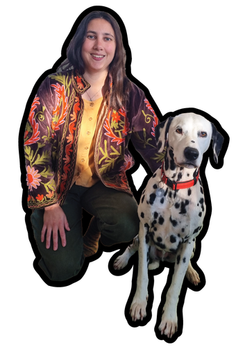 Abbie-Rose Foley in their studio with their Dalmatian