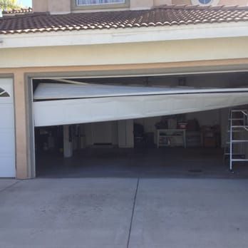 Garage door stuck partially open requiring emergency repair in Winchester, CA