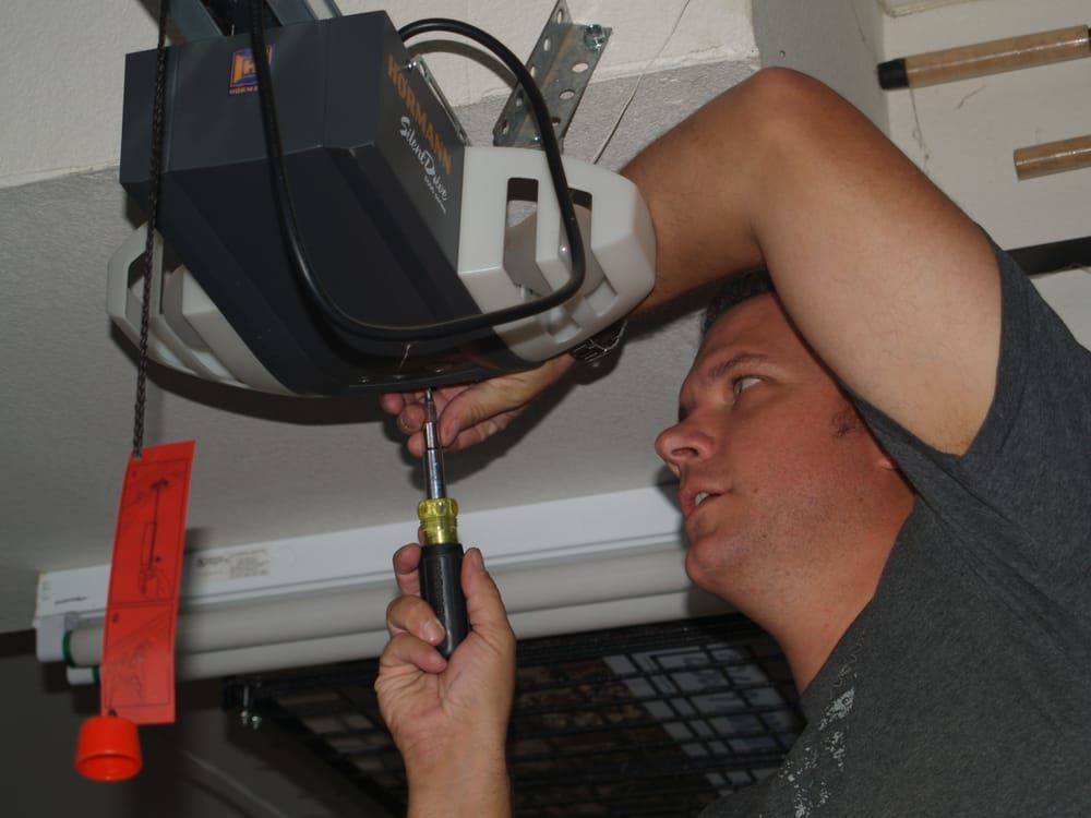Professional technician repairing a garage door same day service.