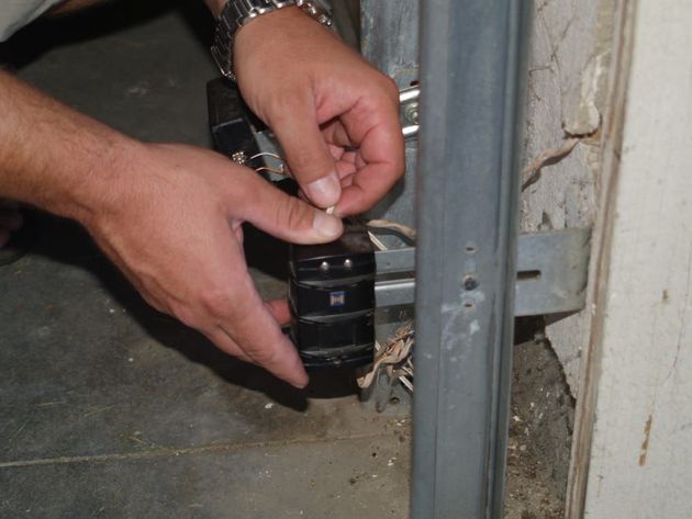 Garage door sensor alignment by Overhead Door Solutions Technician in Winchester CA