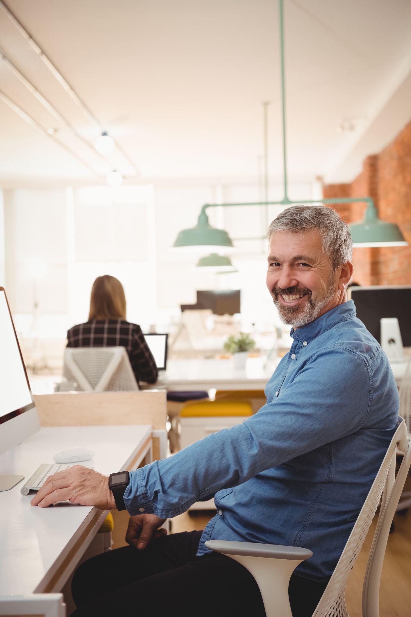 Man Smiles While Working — Dwyer Law Group in Surfers Paradise, QLD