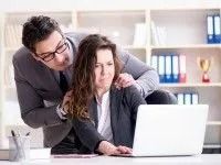 Man Touching Woman's Shoulders While Looking at a Laptop — Dwyer Law Group in Surfers Paradise, QLD